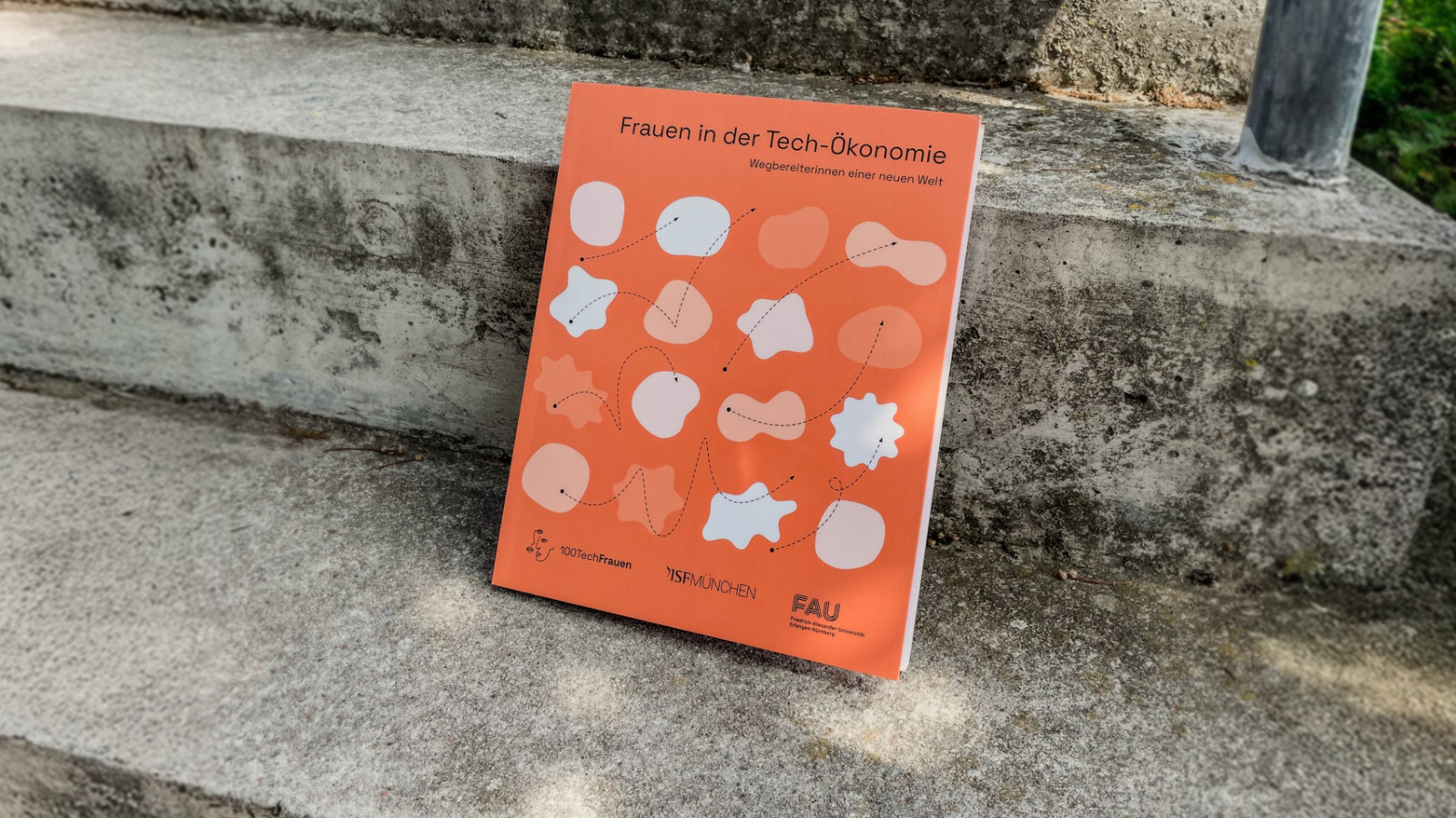 Publication photographed leaning on a step of concrete stairs